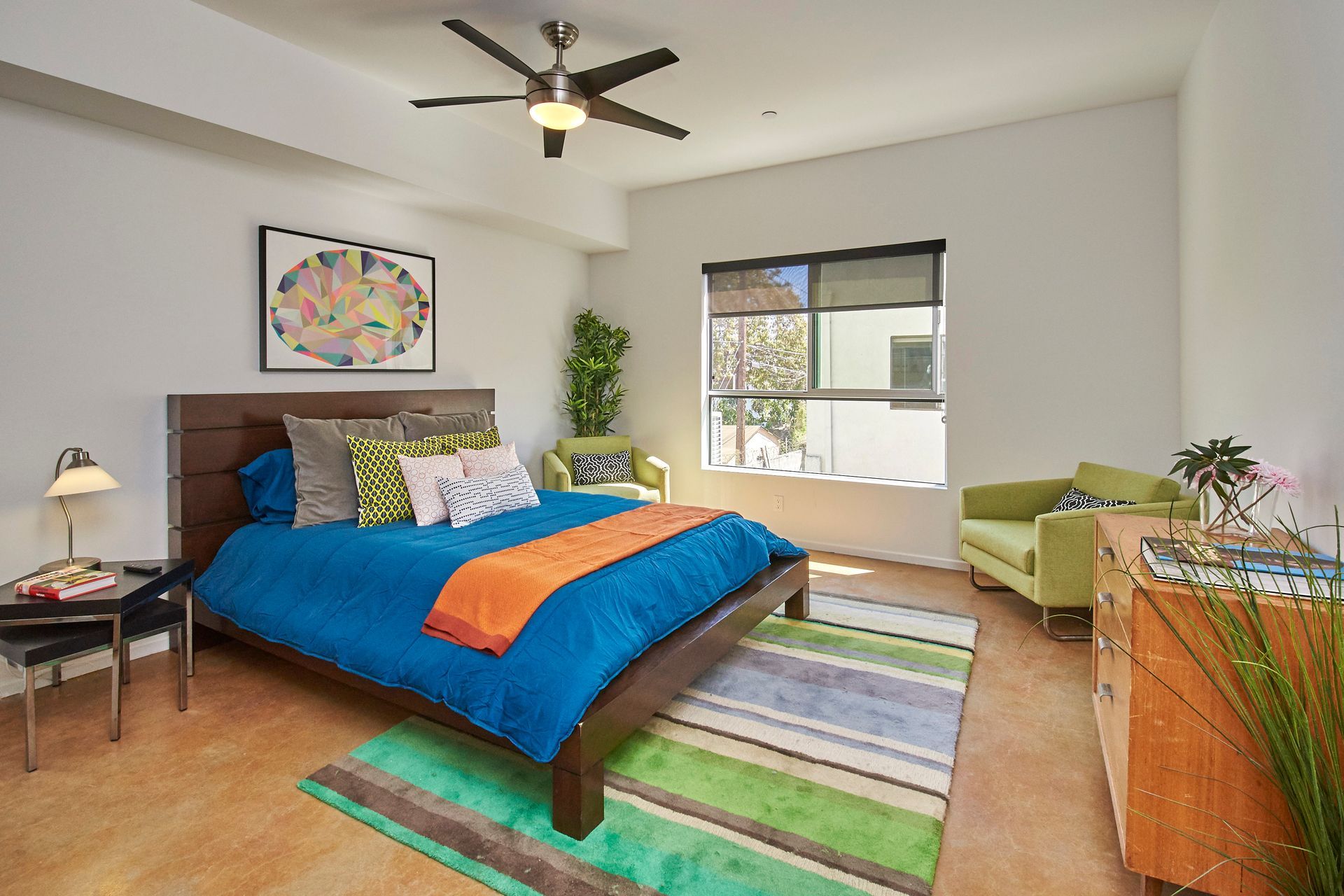 A bedroom with a bed and a ceiling fan