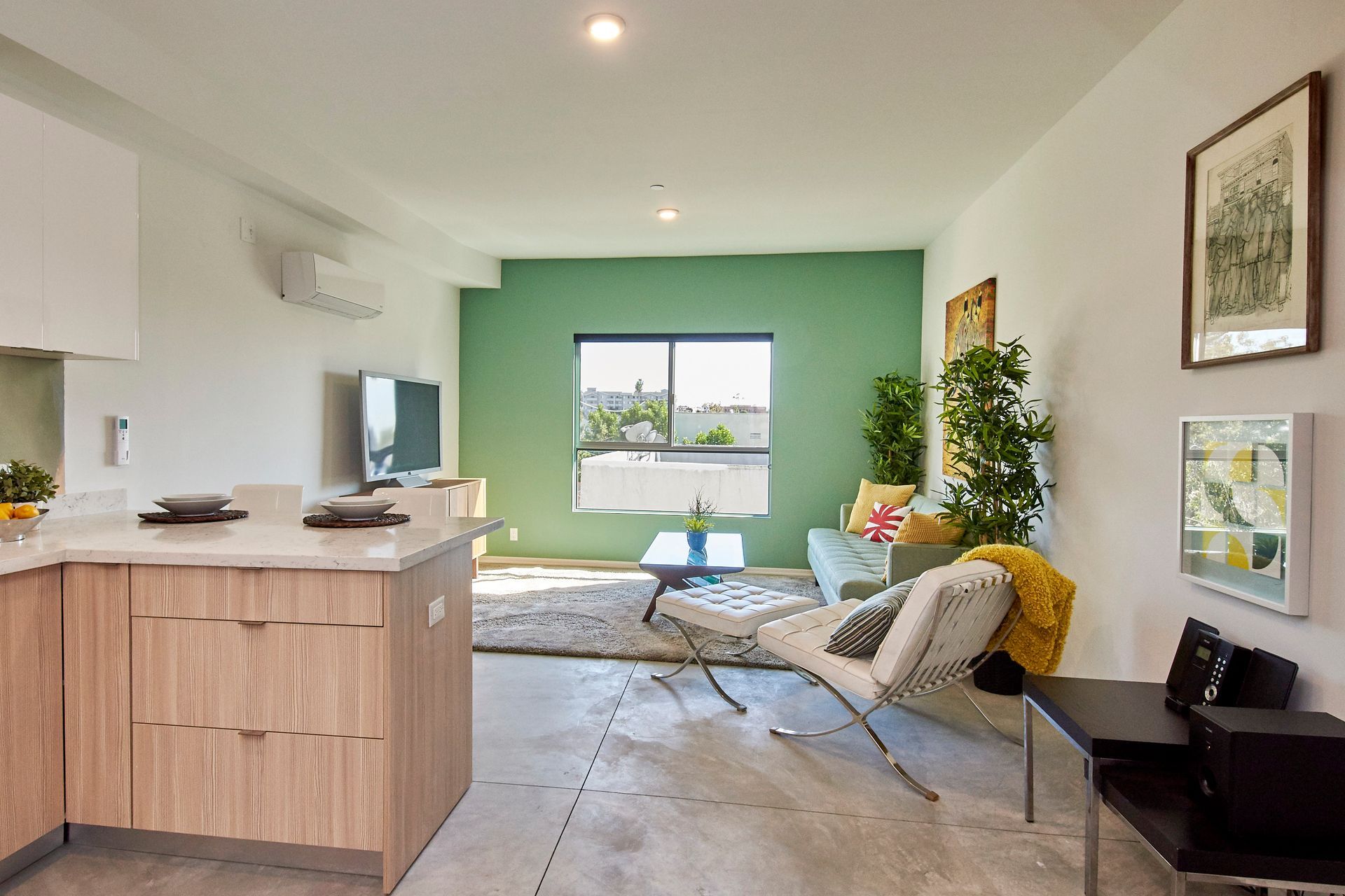 A living room with a green wall and a couch.