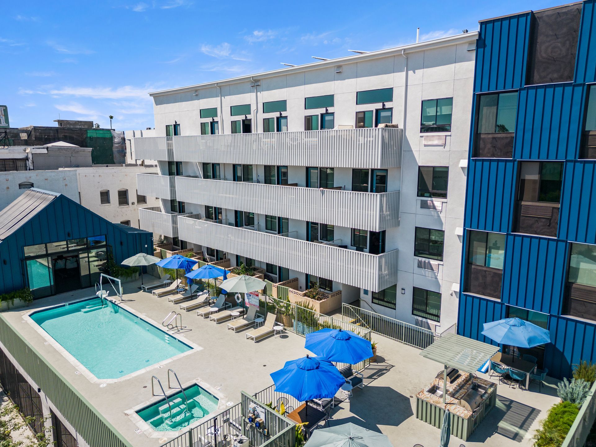 4Mica with a swimming pool and umbrellas in front of it.