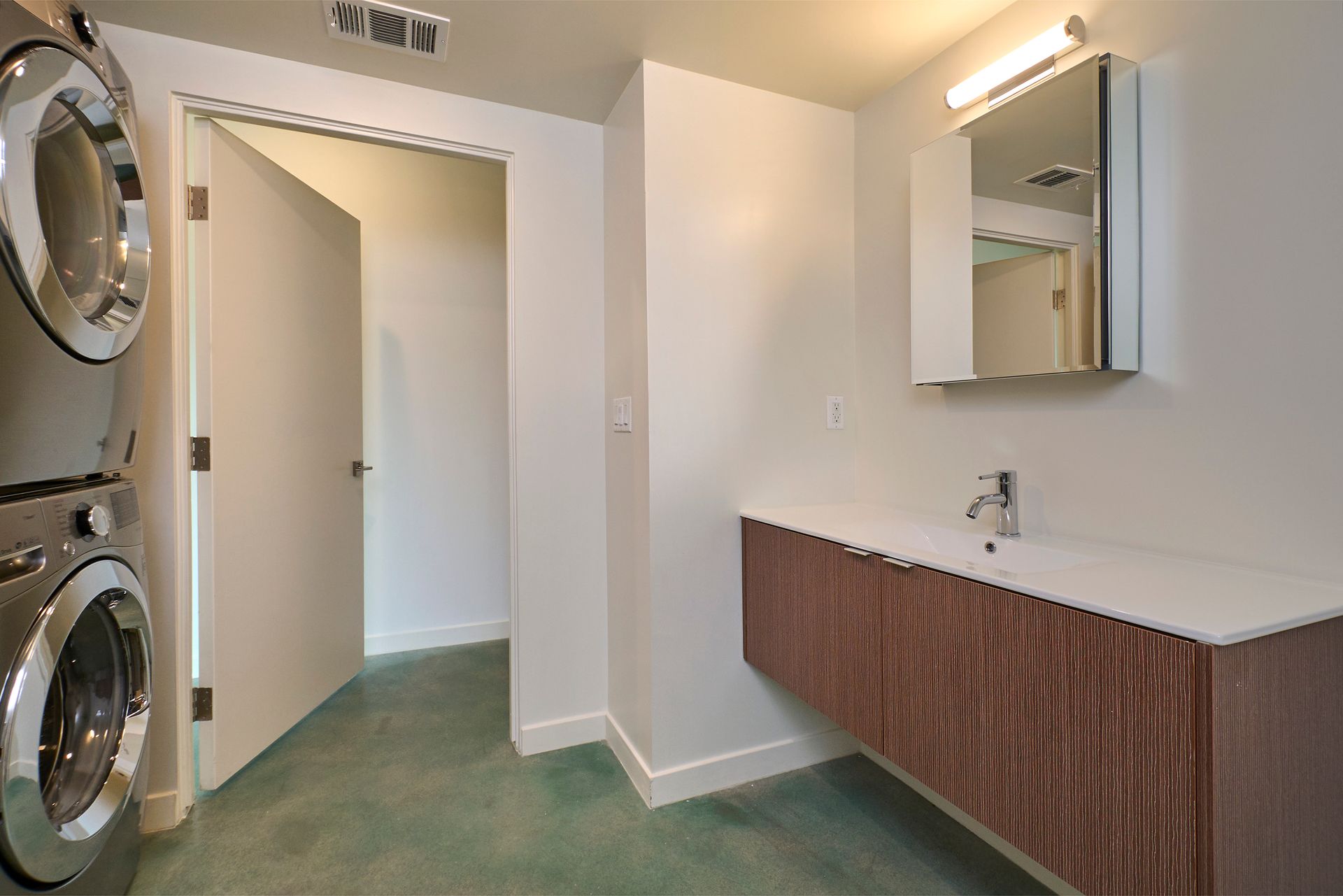A bathroom with a sink and a washer and dryer