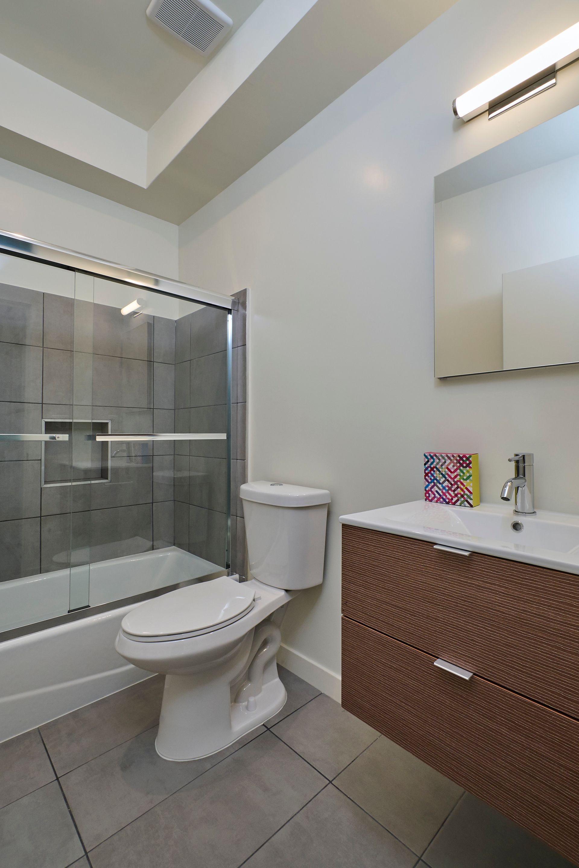 A bathroom with a toilet , sink , and shower.