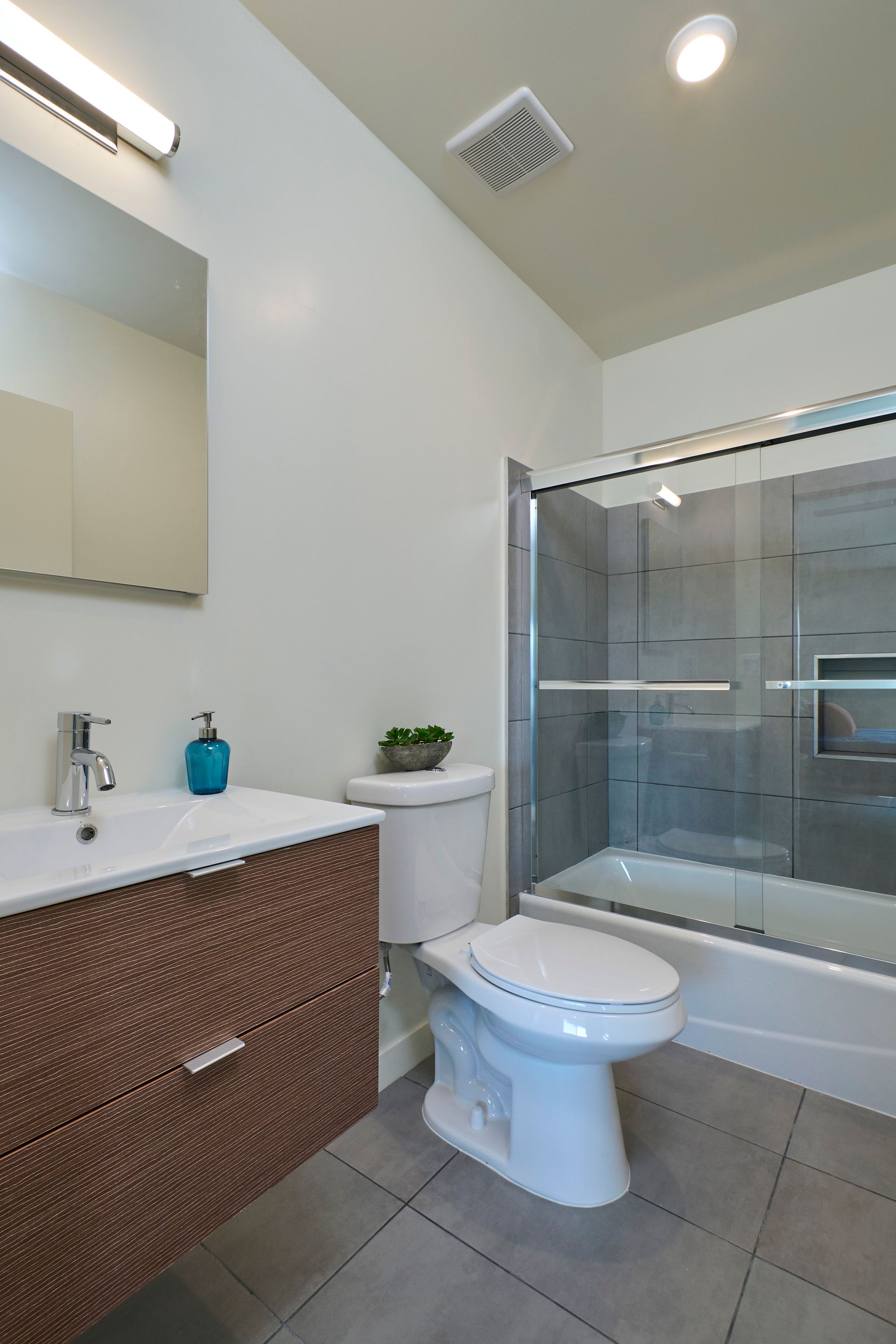 A bathroom with a toilet , sink , and shower.