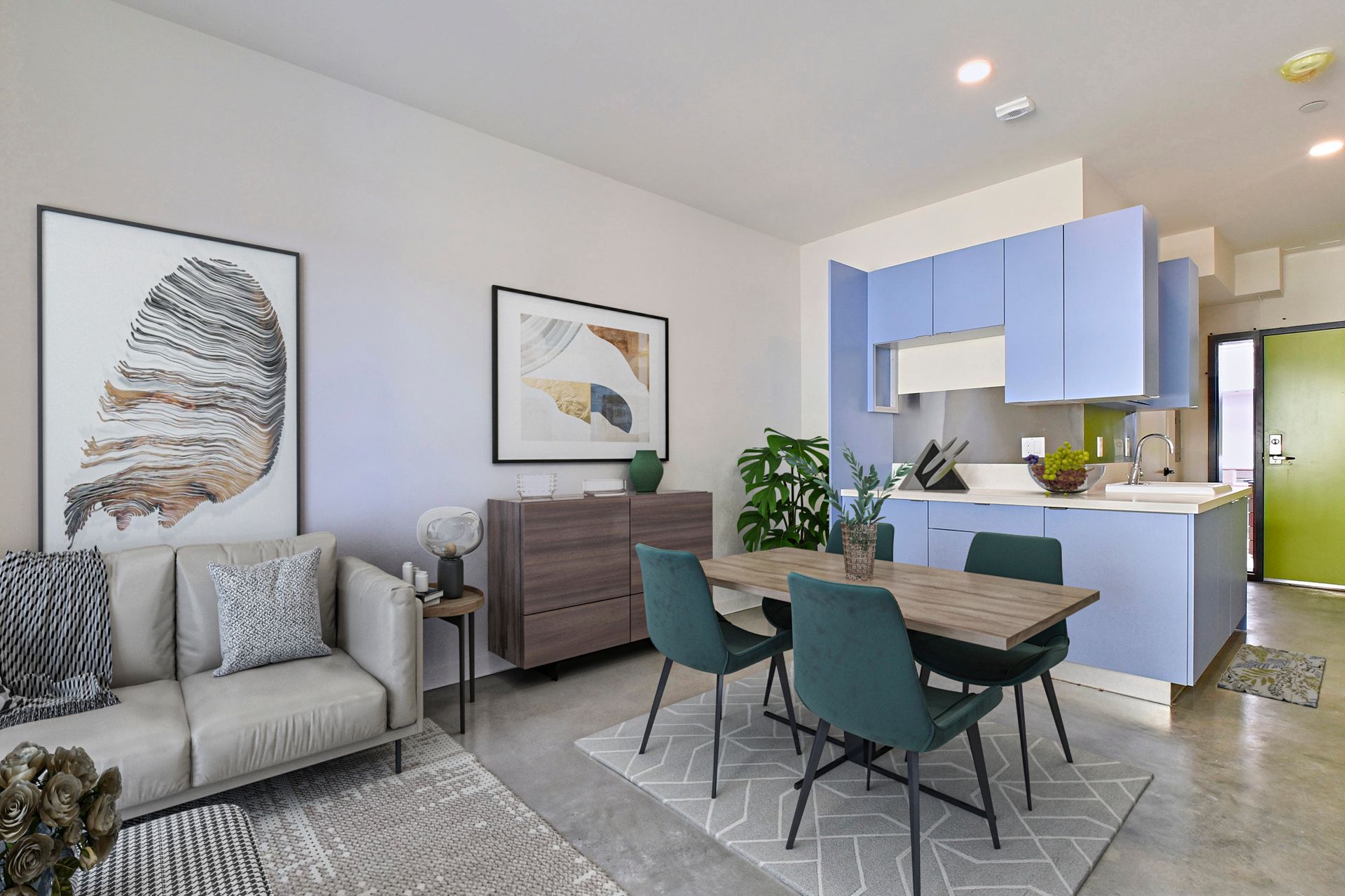 A living room with a couch , table and chairs and a kitchen.
