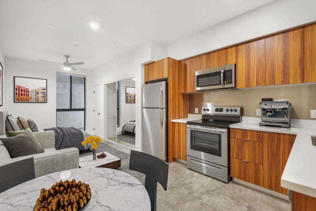 A kitchen with stainless steel appliances and wooden cabinets