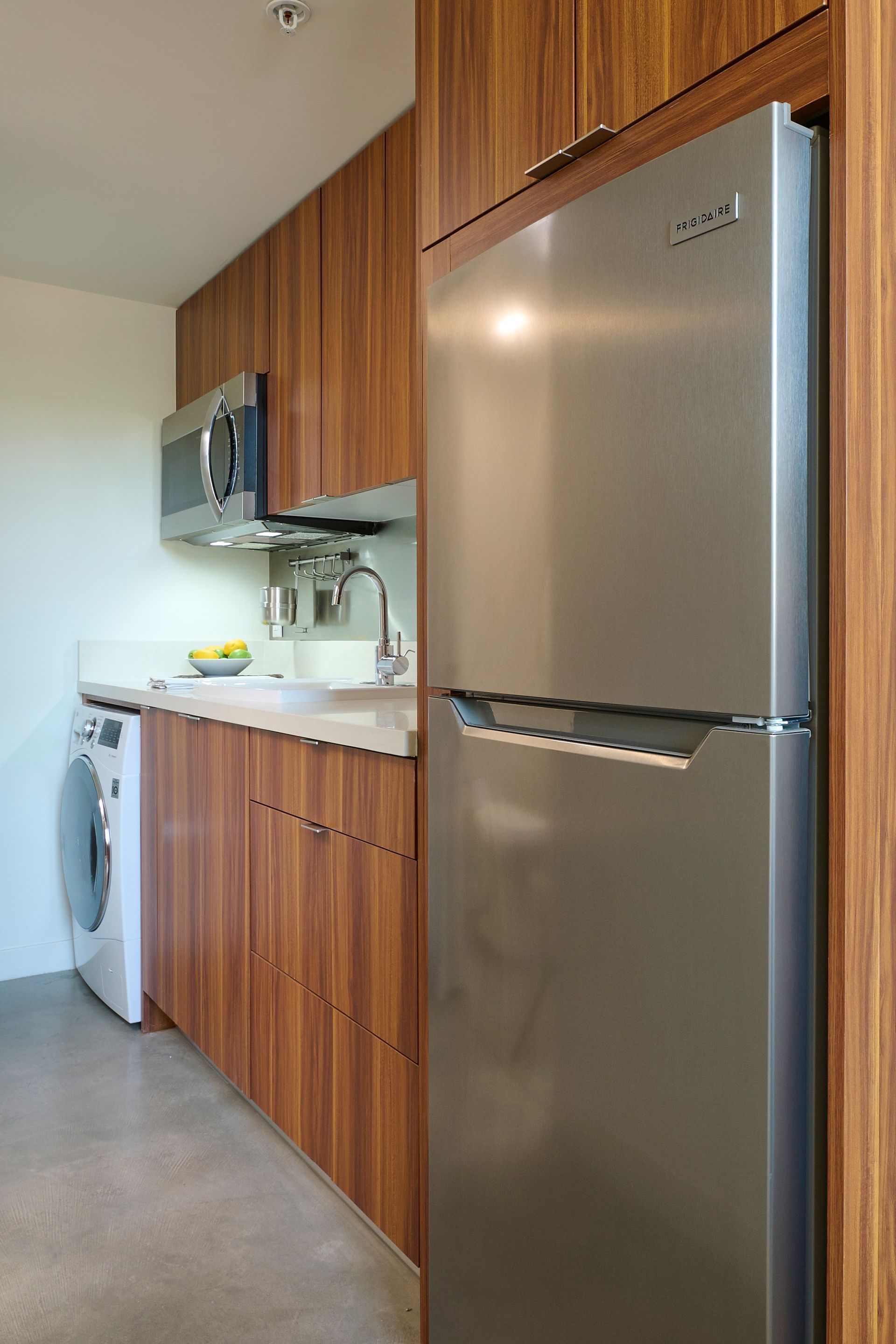 A kitchen with stainless steel appliances and wooden cabinets.