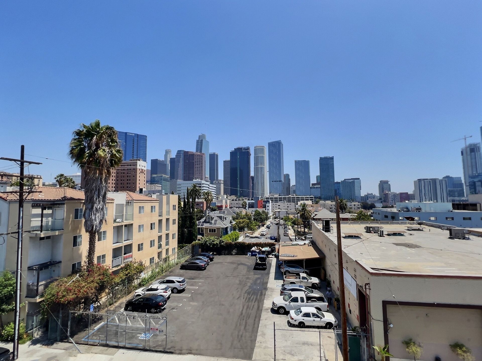 An aerial view of a city skyline with a parking lot in the foreground.