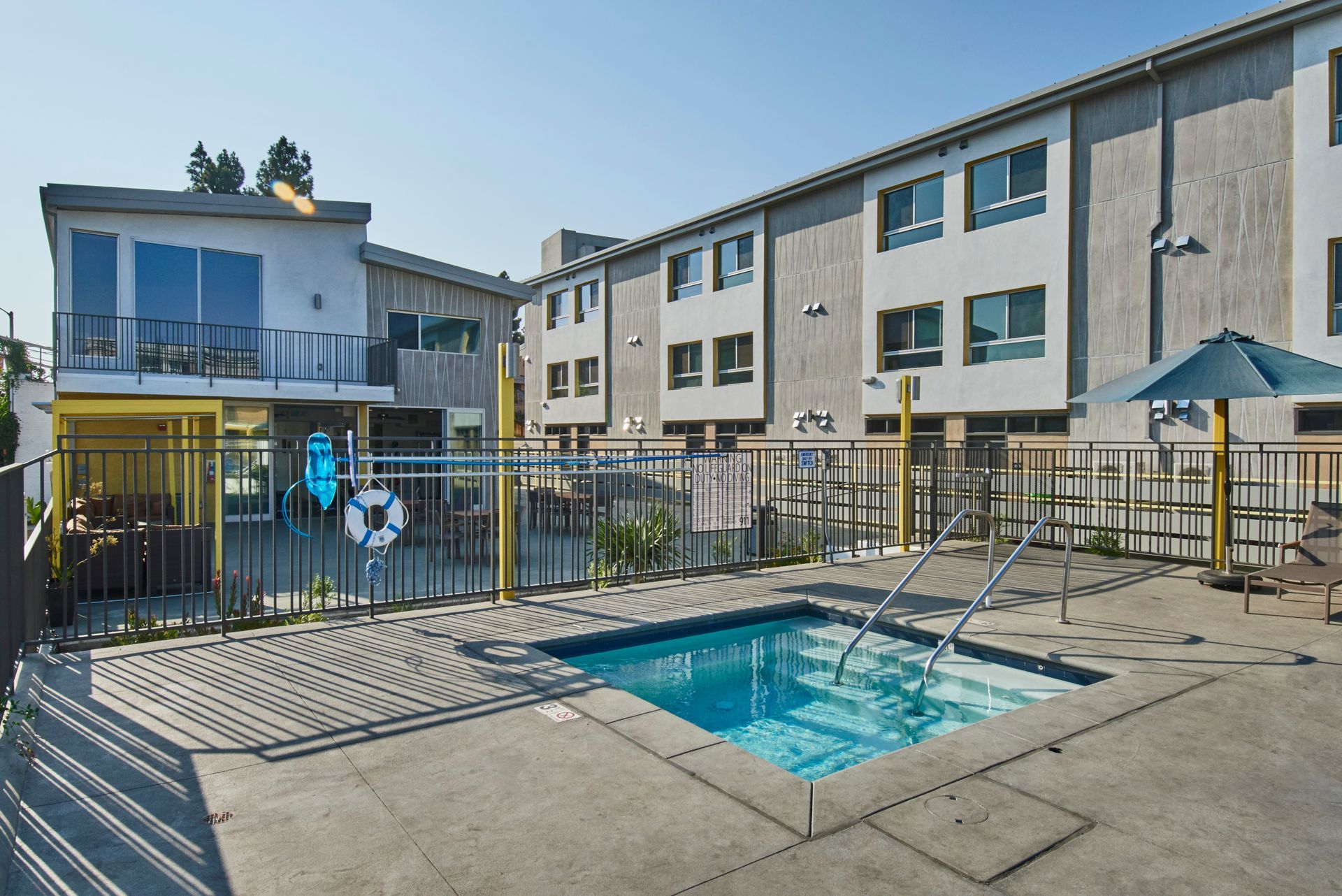 A large building with a swimming pool in front of it
