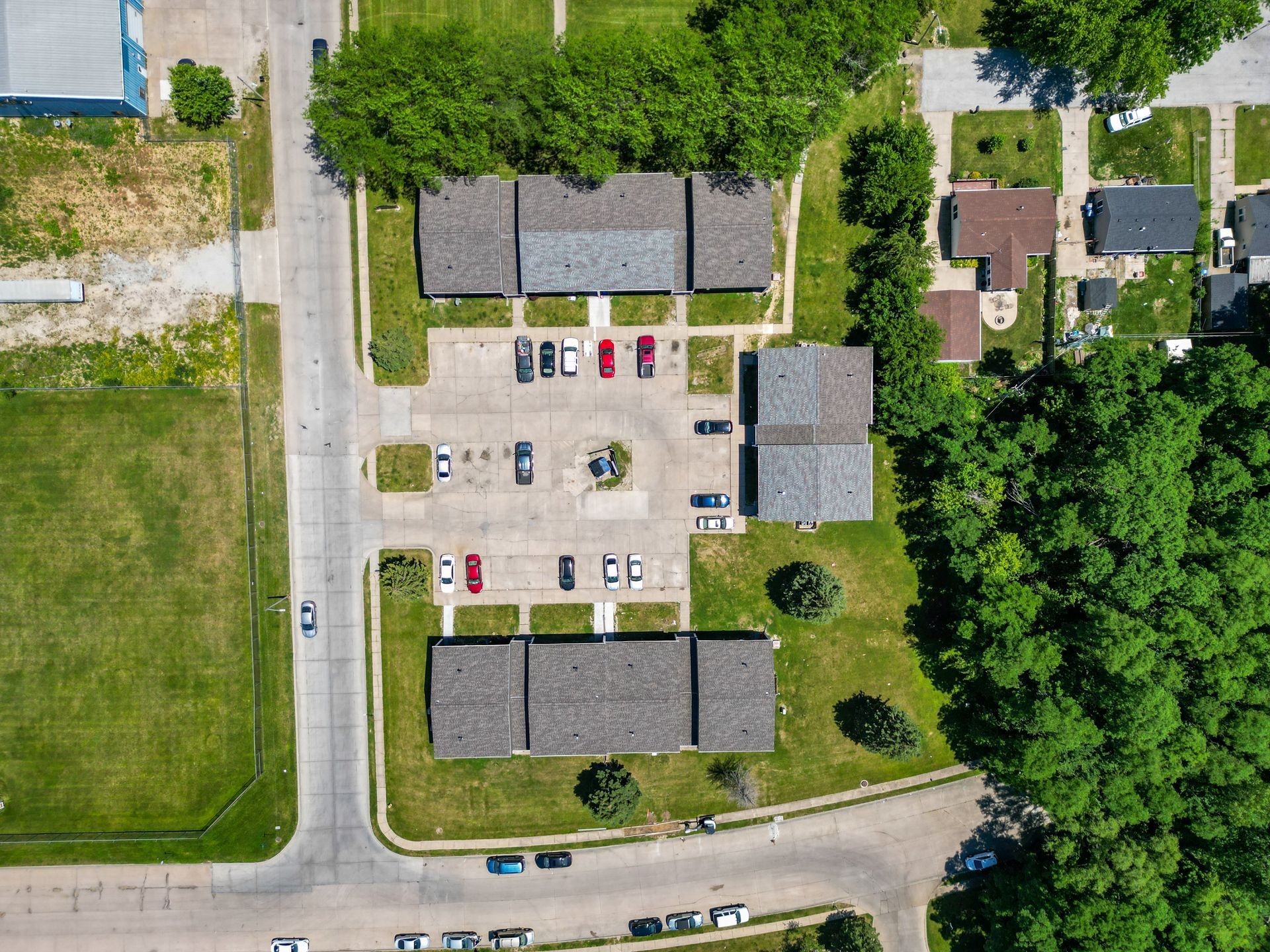 An aerial view of a residential area with lots of trees and buildings