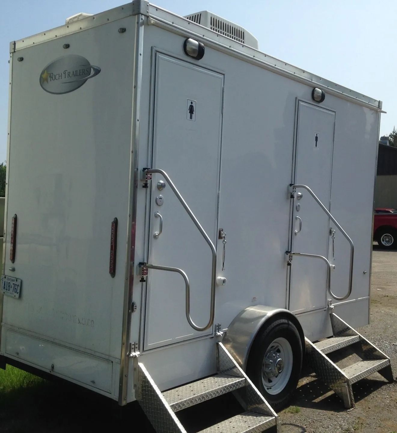 A white trailer with stairs and a sign that says ' no 1 ' on it