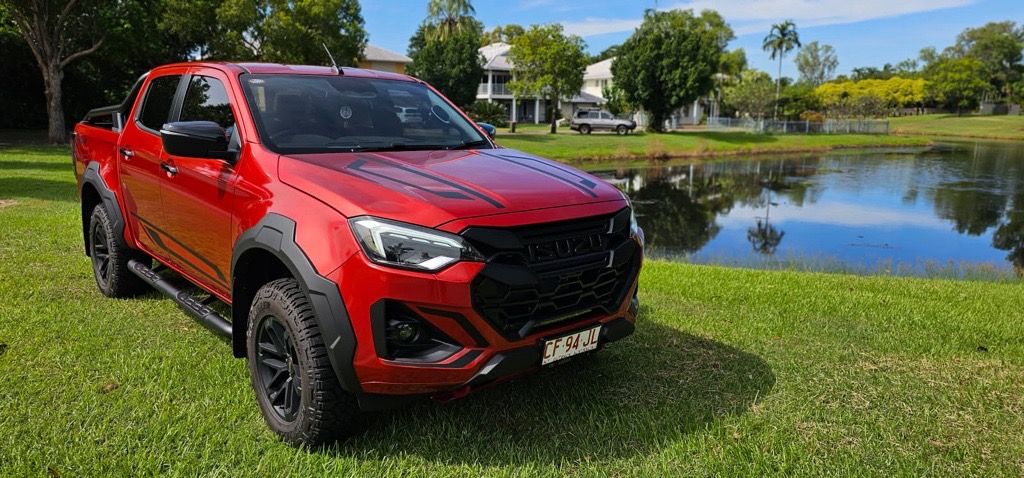 A Red Isuzu dmax parked on grass — NT Auto Repairs in Winnellie, NT