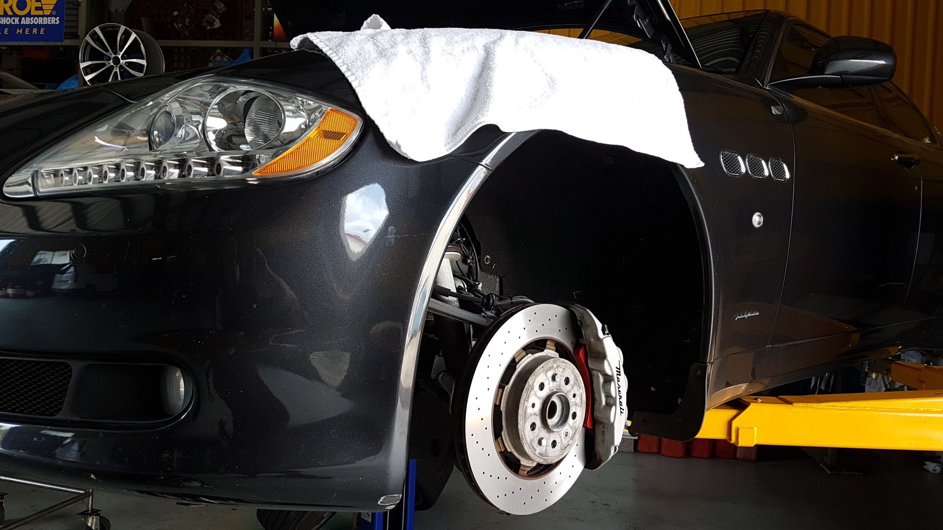 A Close Up of a Car Exhaust Pipe With a Tire in the Background — NT Auto Repairs in Winnellie, NT