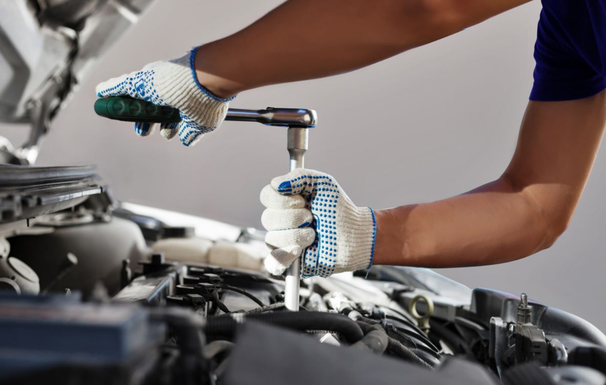 A Person is Working on a Car Engine With a Wrench — NT Auto Repairs in Winnellie, NT