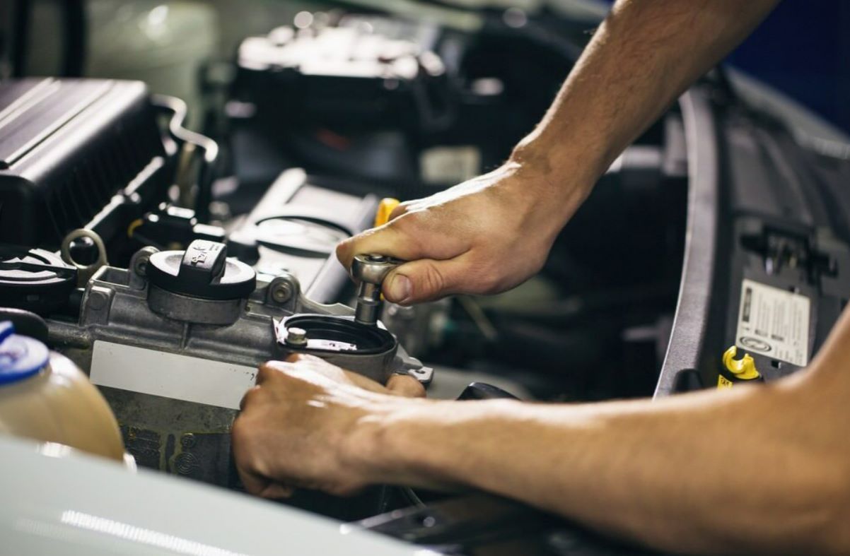 A Man is Working on the Engine of a Car — NT Auto Repairs in Winnellie, NT