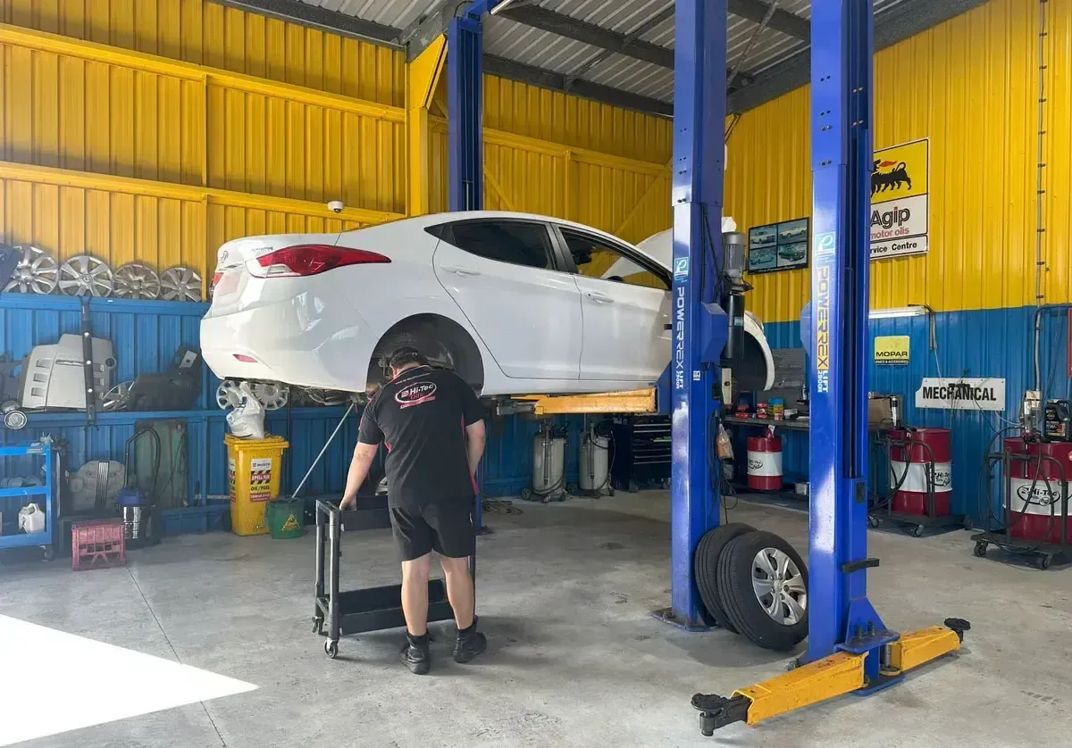 A Man is Working on a Car In A Mechanic Workshop — NT Auto Repairs in Winnellie, NT