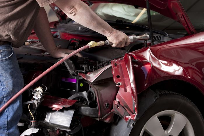 Auto Body Mechanic Disassembling Damaged Vehicle - Rome, NY - DM Collision