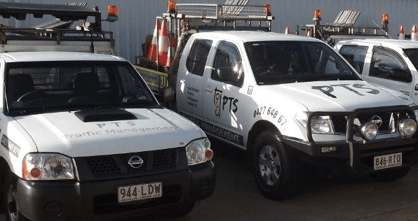 Two Nissan Trucks Are Parked Next To Each Other In A Parking Lot — PTS Traffic Management in Smithfield, QLD