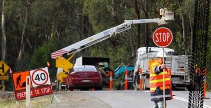 A Stop Sign Is Being Installed On The Side Of The Road — PTS Traffic Management in Smithfield, QLD