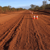 A Dirt Road With Traffic Cones On The Side Of It — PTS Traffic Management in Smithfield, QLD