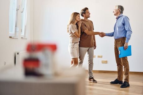Couple shaking hands with HVAC sales person.