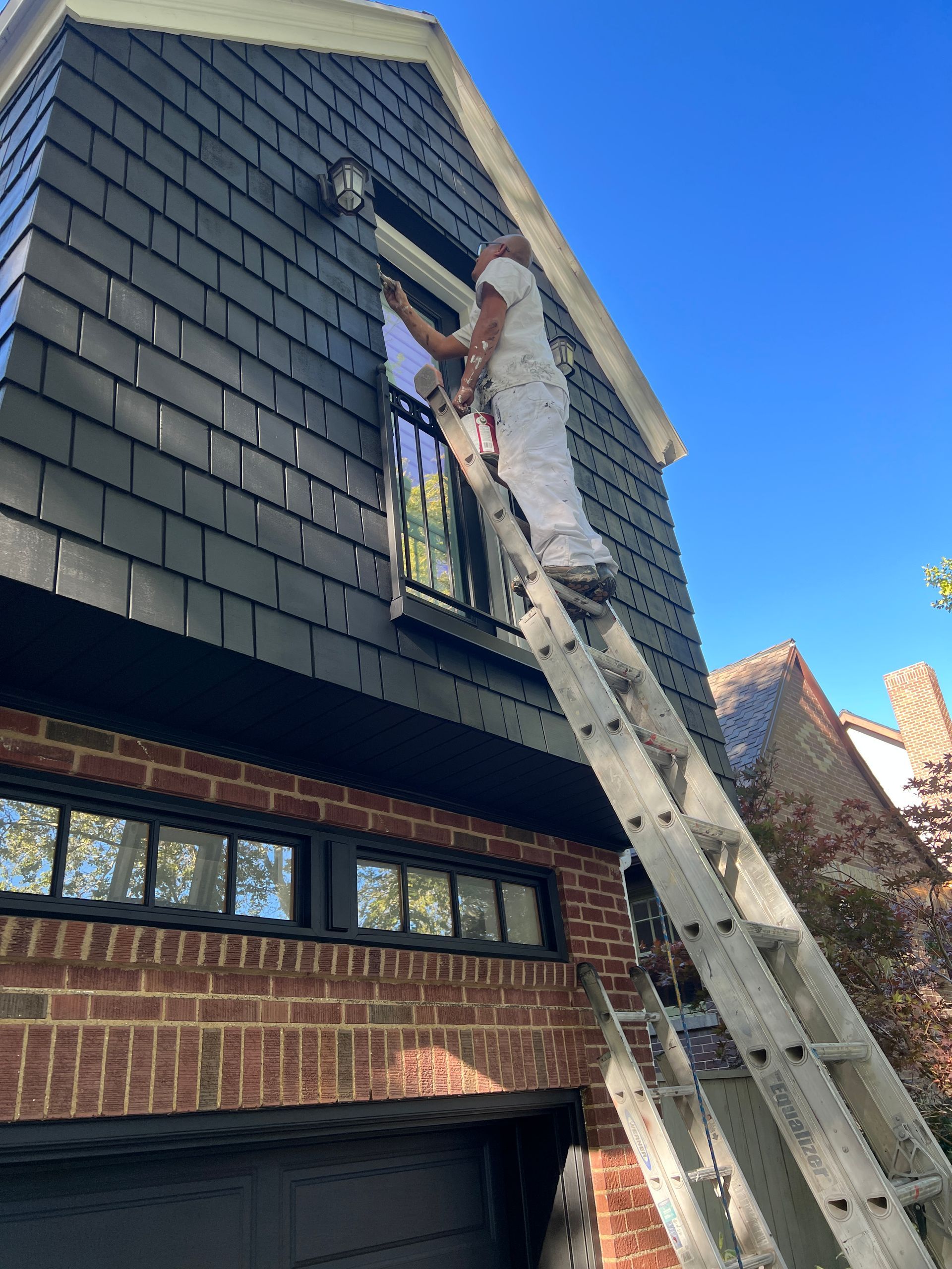 worker painting the house