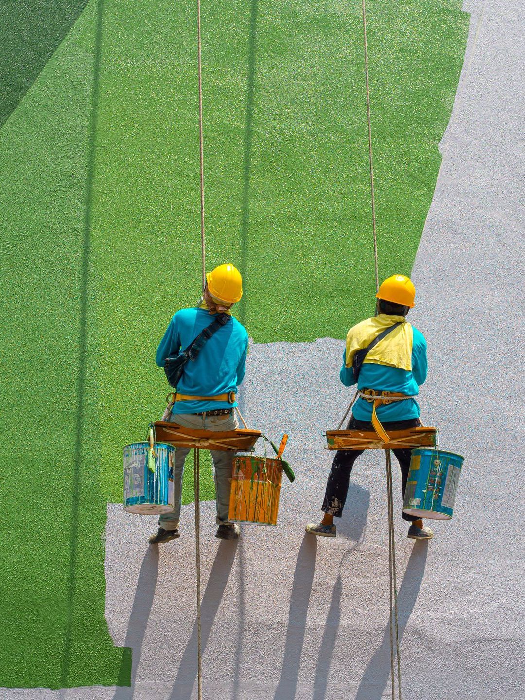 men painting building exterior