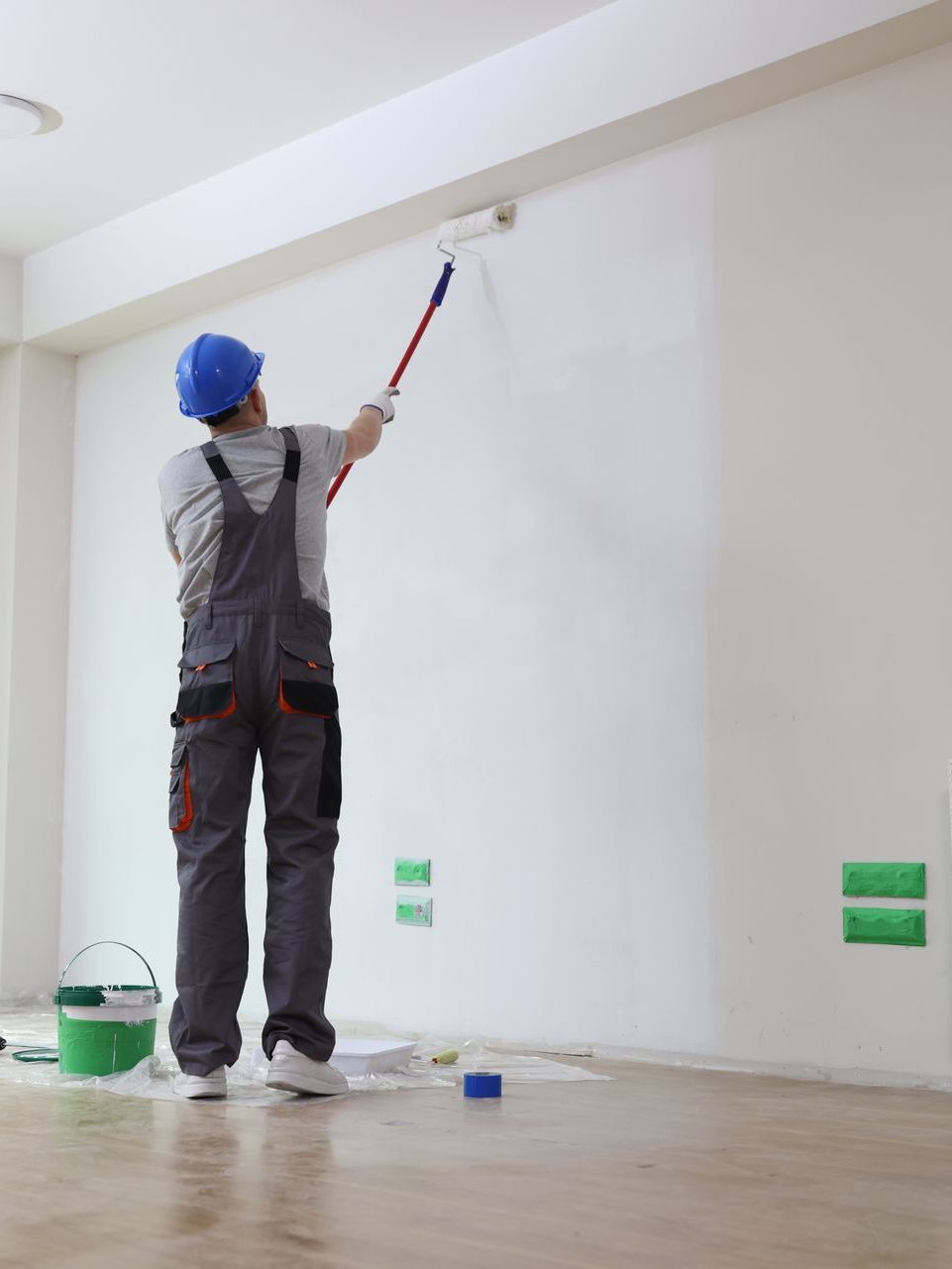 man painting new house