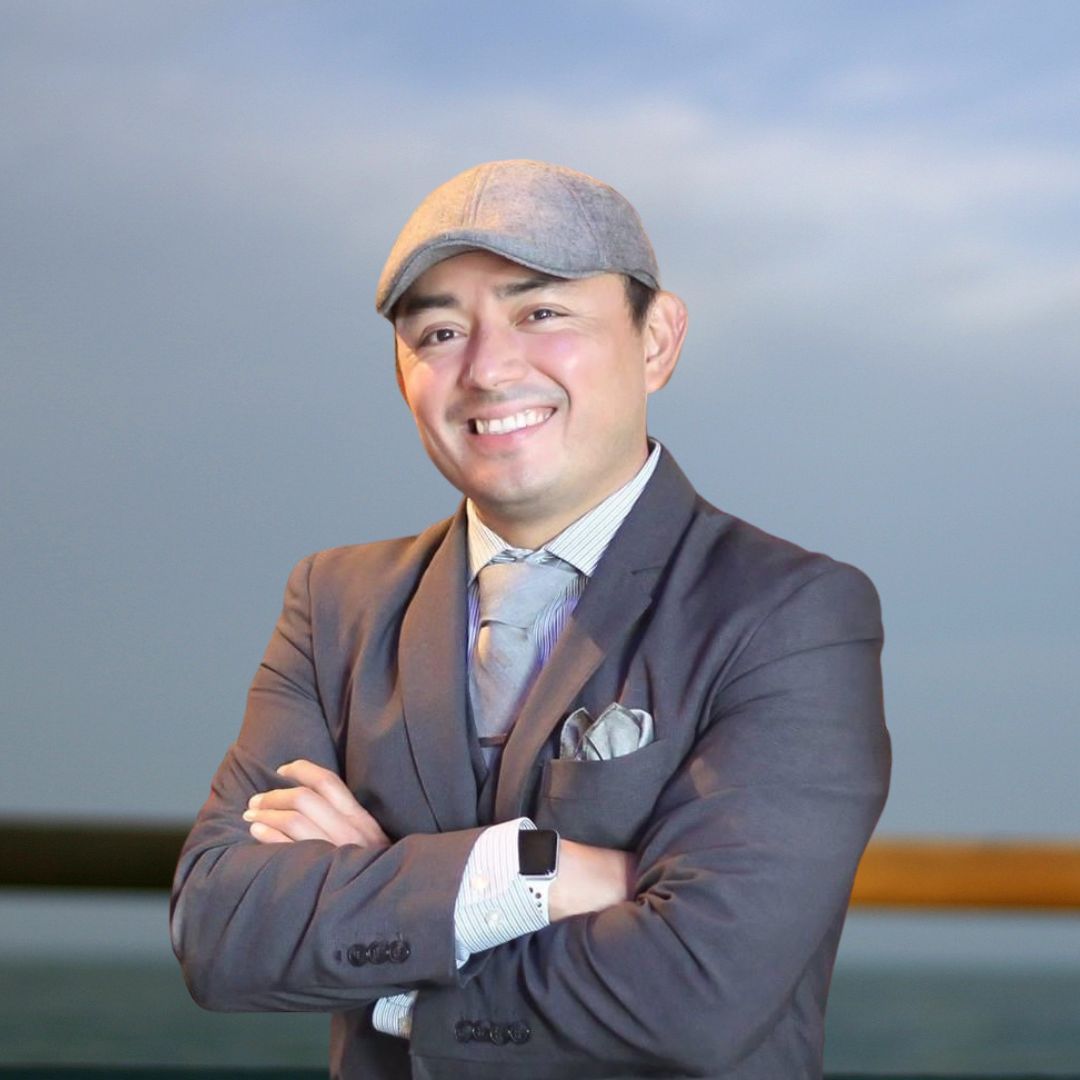 a man in a suit and hat is standing in front of a bar full of liquor bottles .