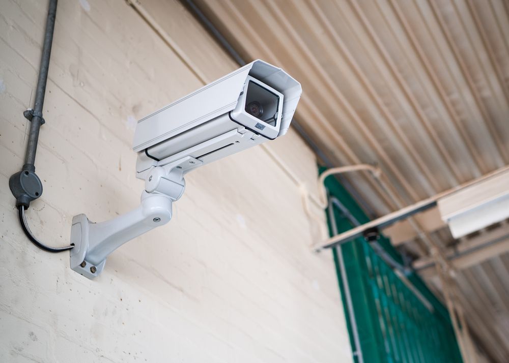 a security camera is mounted on the side of a building .