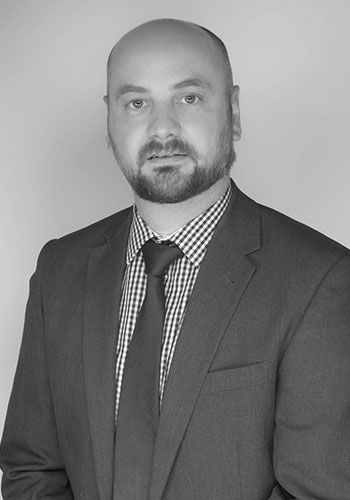 daniel at sabre insurance with a beard is wearing a suit and tie .