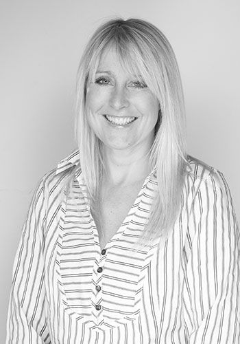 mel at sabre insurance in a striped shirt is smiling in a black and white photo .