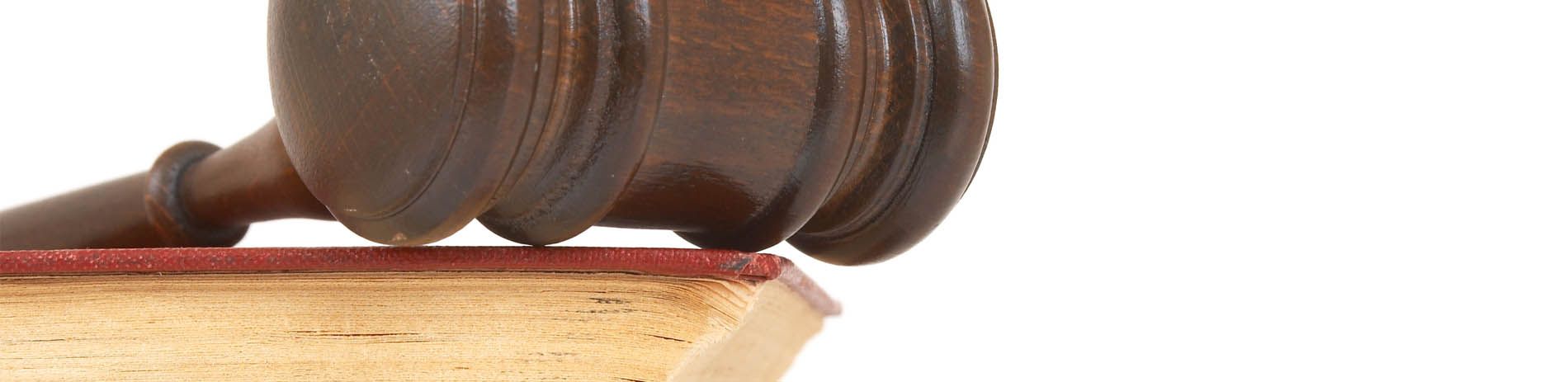 a wooden gavel is sitting on top of a piece of wood .
