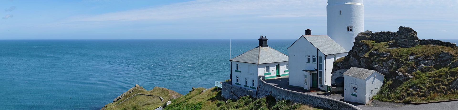 an aerial view of start point lighthouse on a cliff overlooking the ocean .