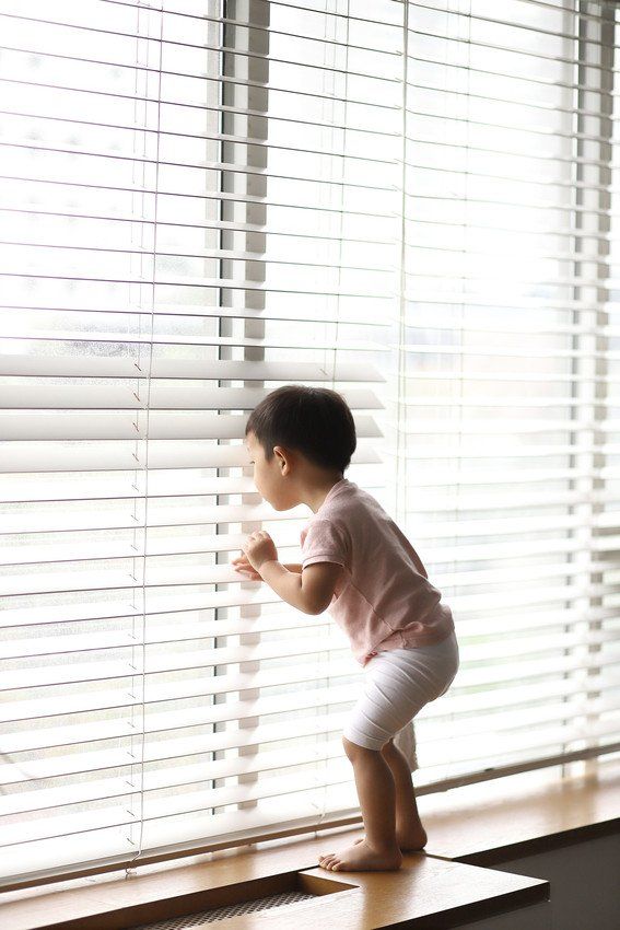 Baby boy looking out window