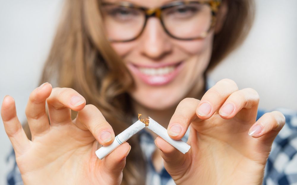 Man breaking cigarette in half