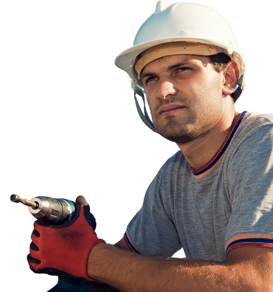 A man wearing a hard hat and gloves is holding a drill