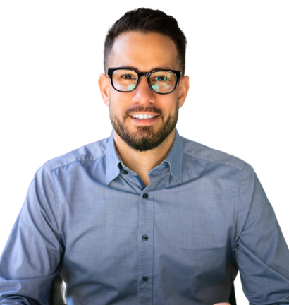 A man wearing glasses and a blue shirt is smiling