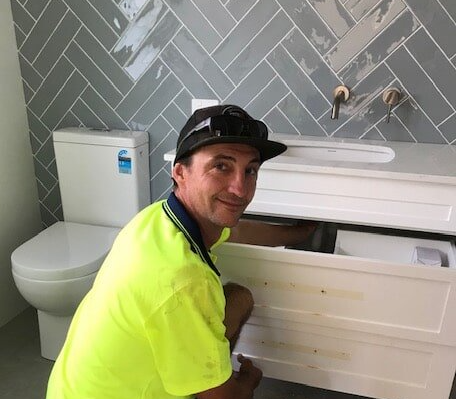 Plumber Inside The Bathroom — Henderson Plumbing & Excavations in Heads South, NSW
