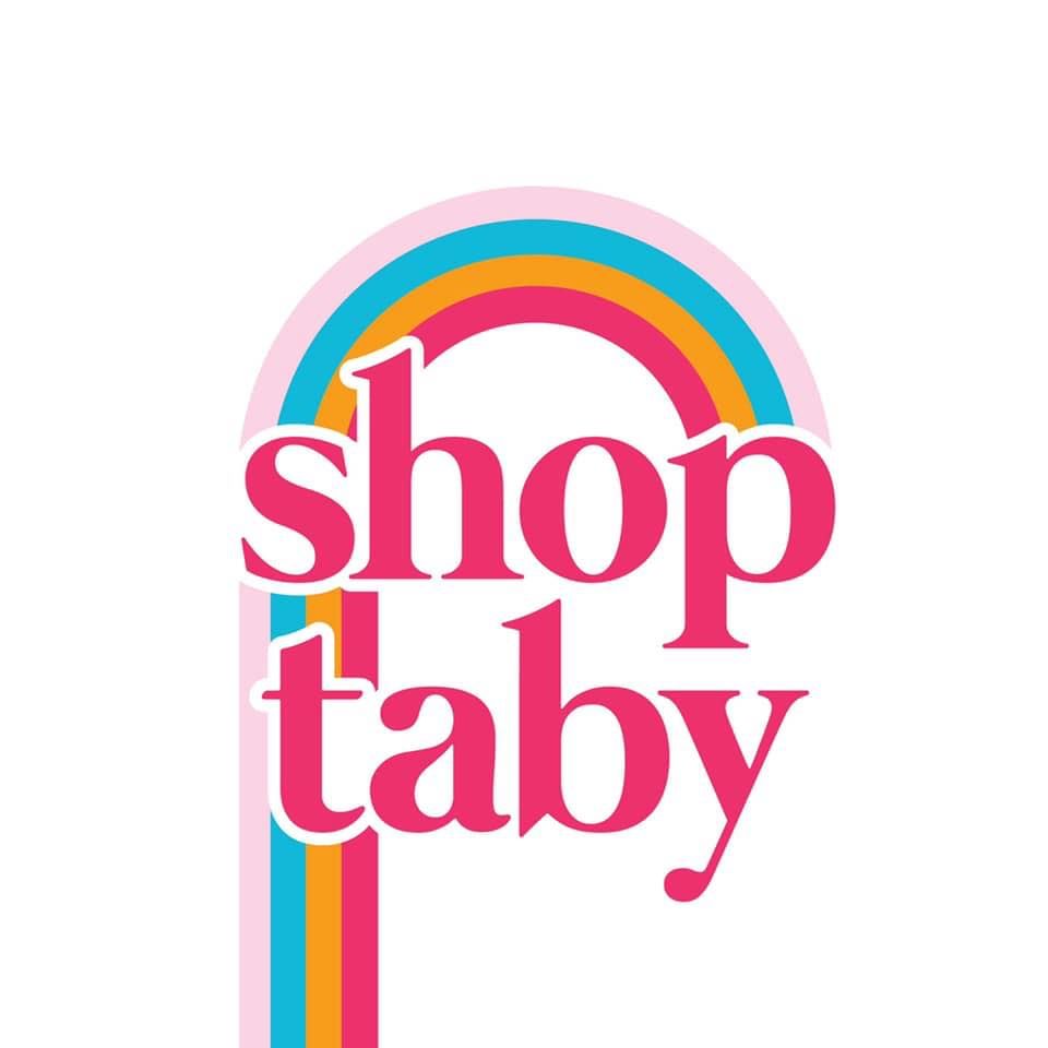 A logo for shop taby with a rainbow in the background
