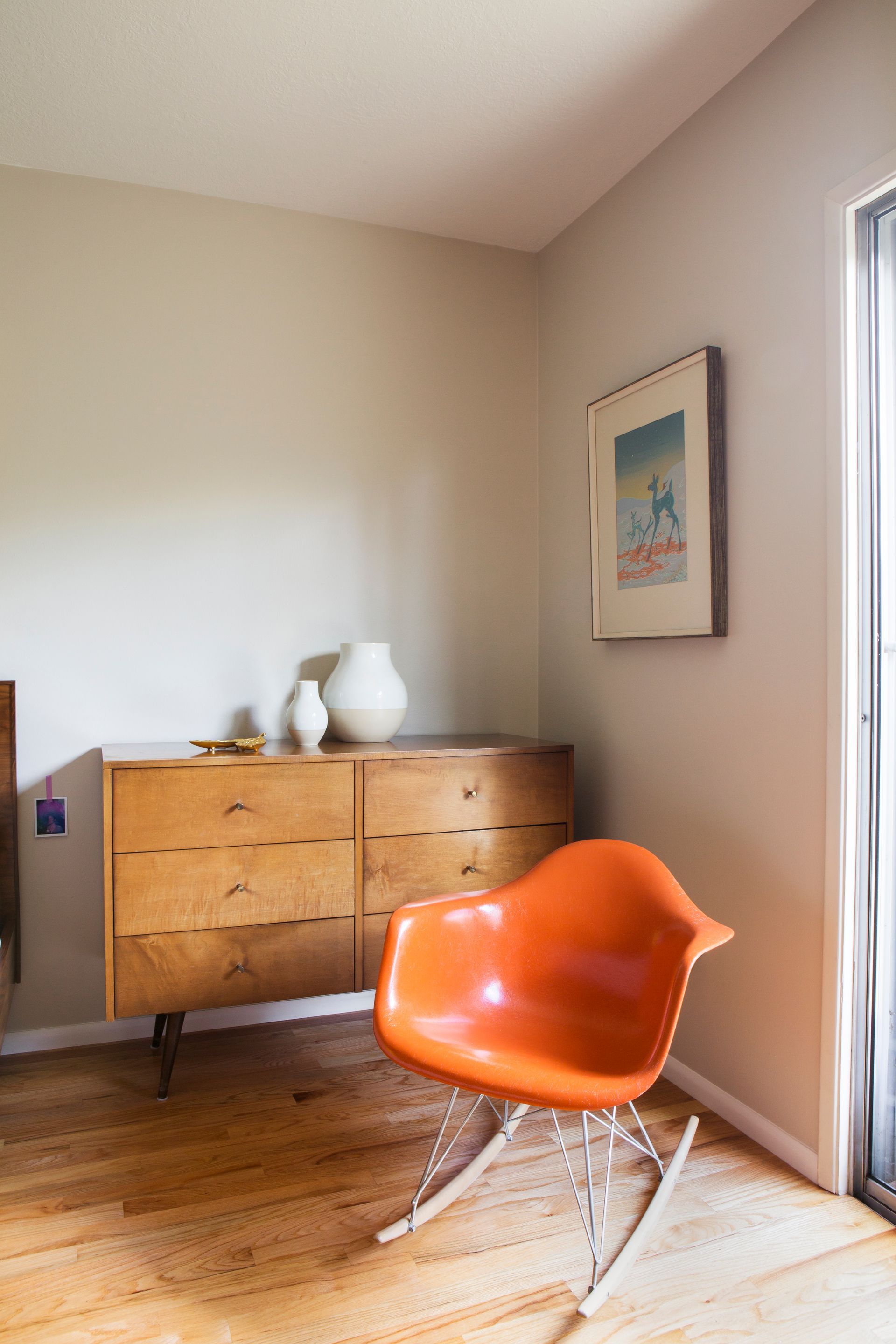 Rustic modern cabin living room design with stone fireplace, leather lounge chairs, wood ceiling, and forest views