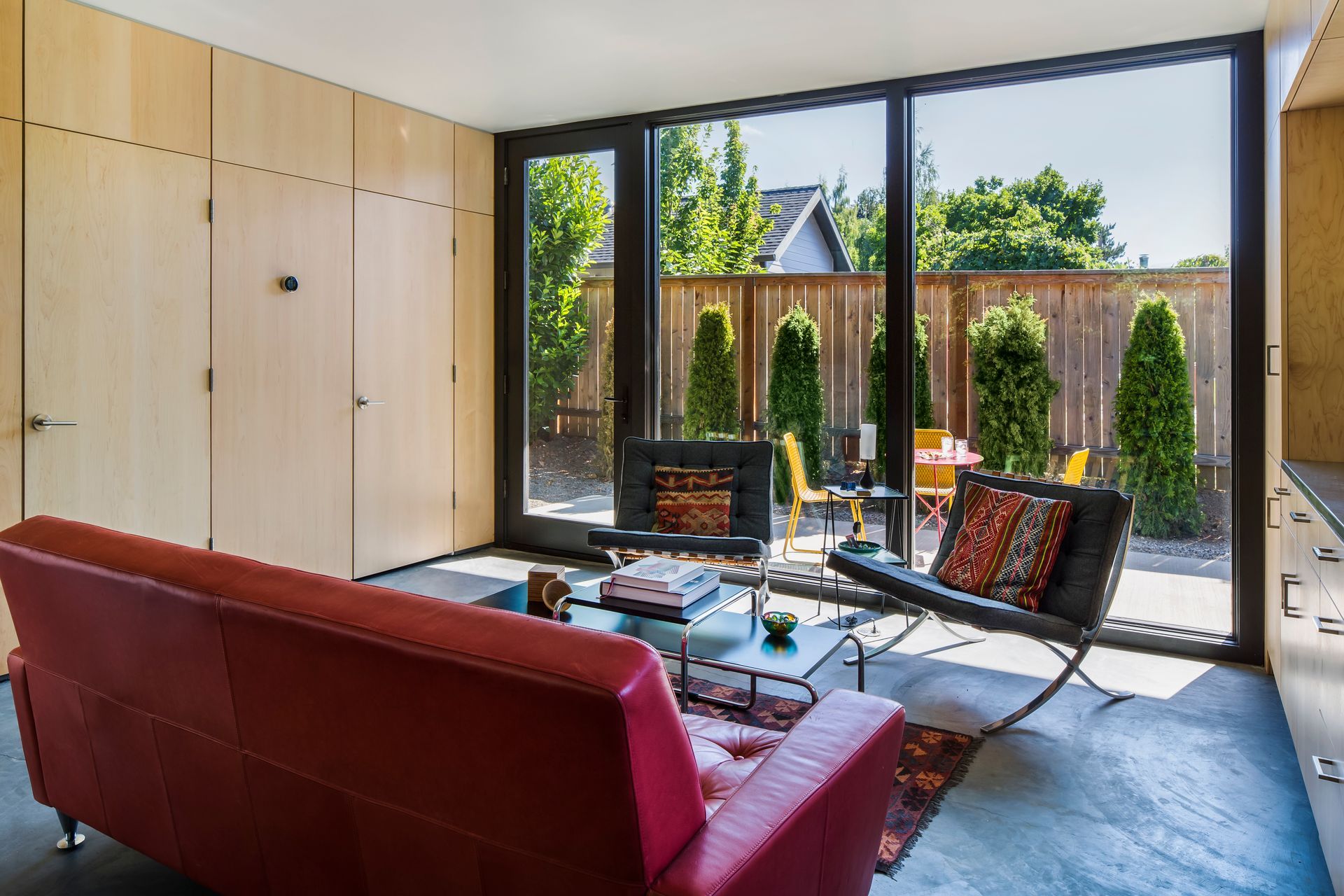 open kitchen living space with red sofa and indoor outdoor connection Portland Oregon