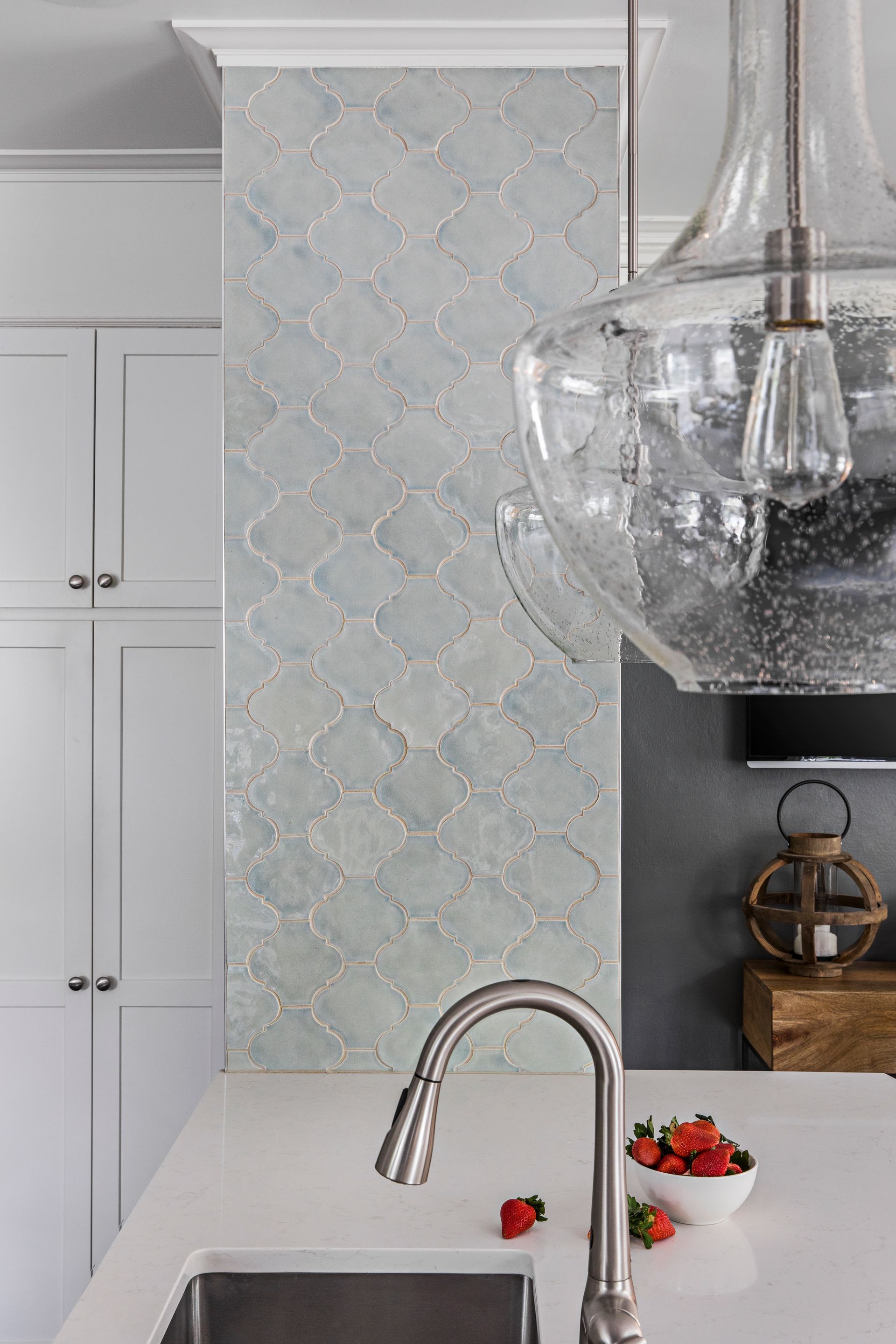 airy kitchen with soft blue walls, marble surfaces and glass pendant lighting Portland Oregon