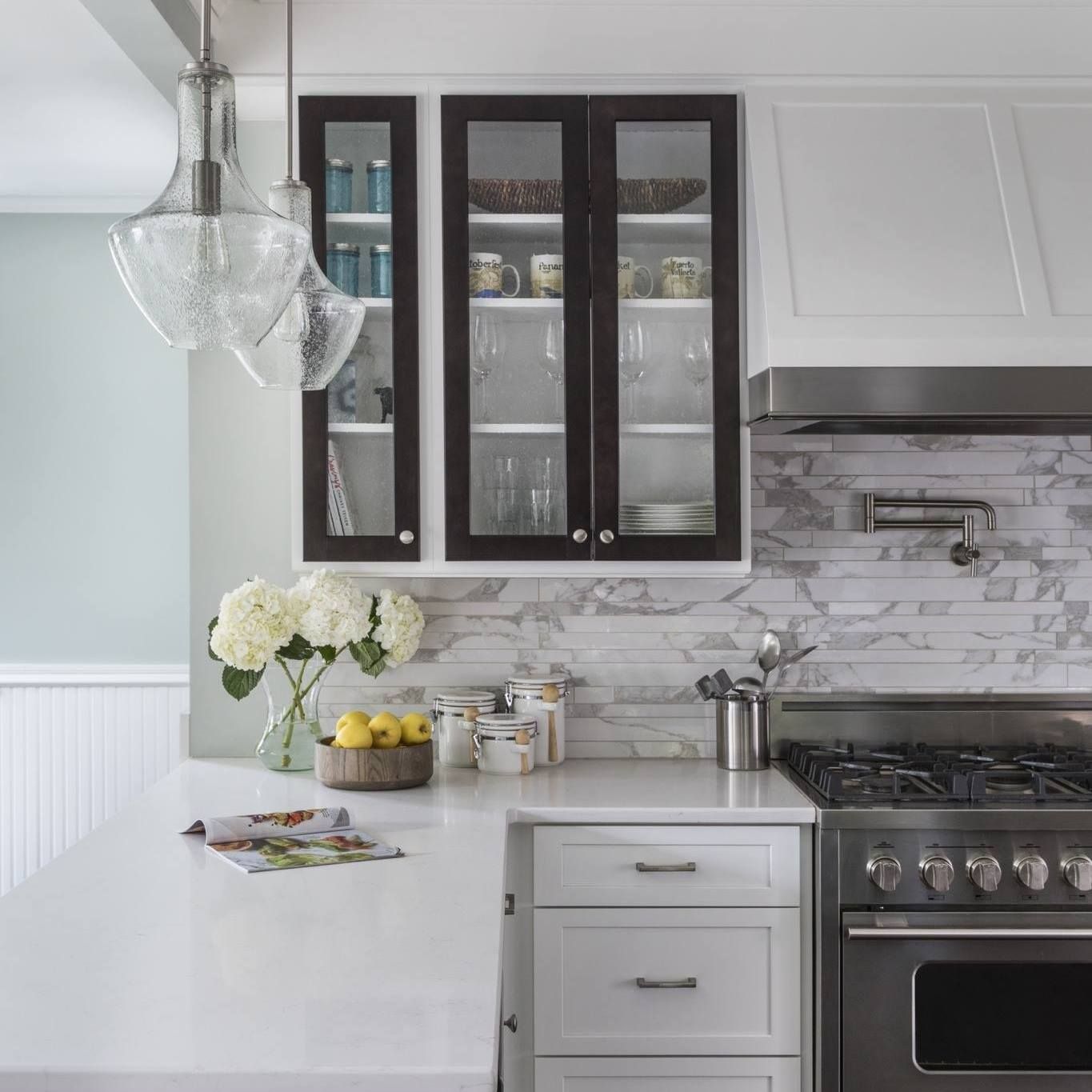 A bright Portland kitchen remodel featuring marble countertops, light cabinetry, and a timeless, refined design approach.
