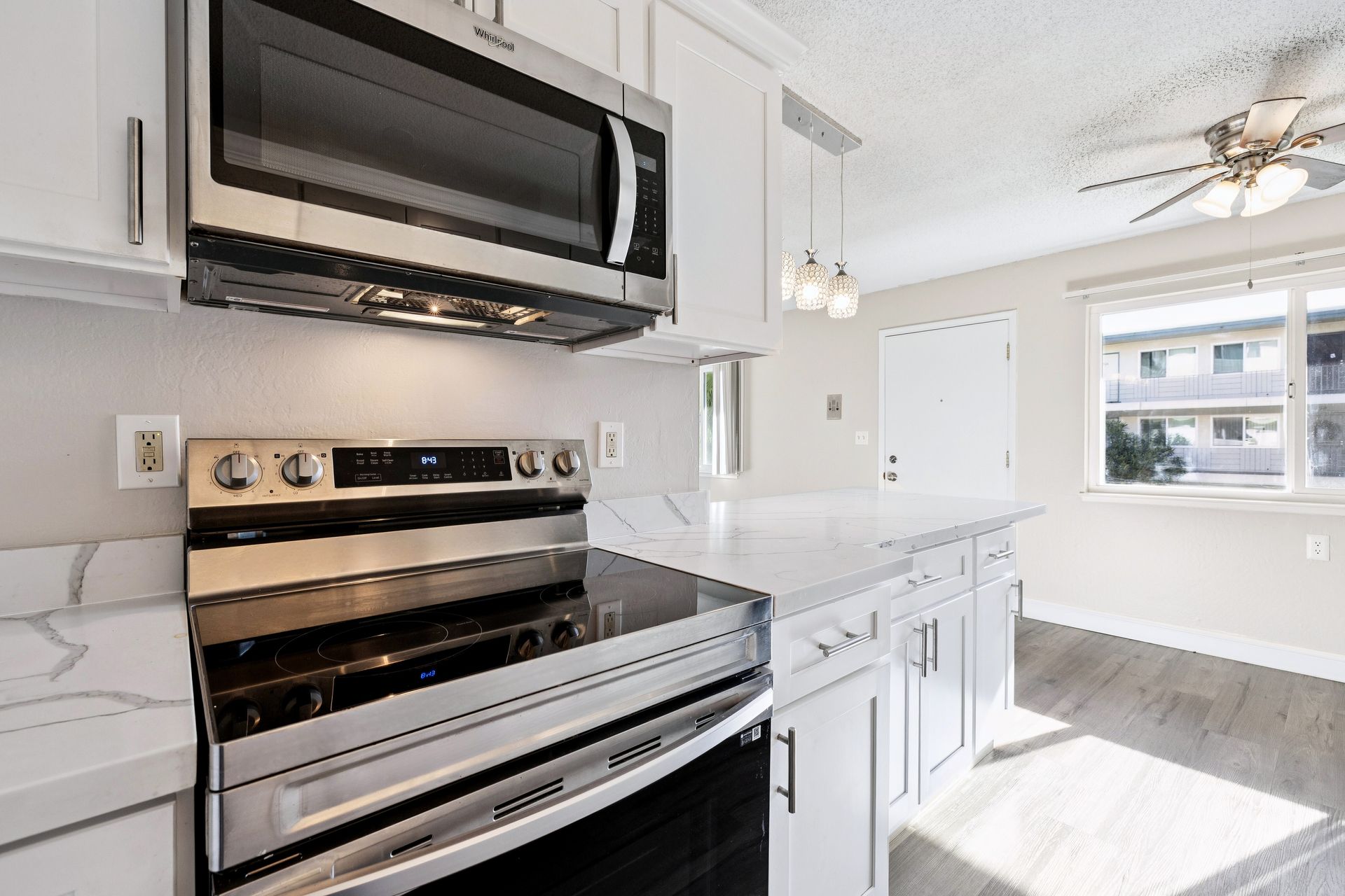 bright, renovated kitchen and furnished living room