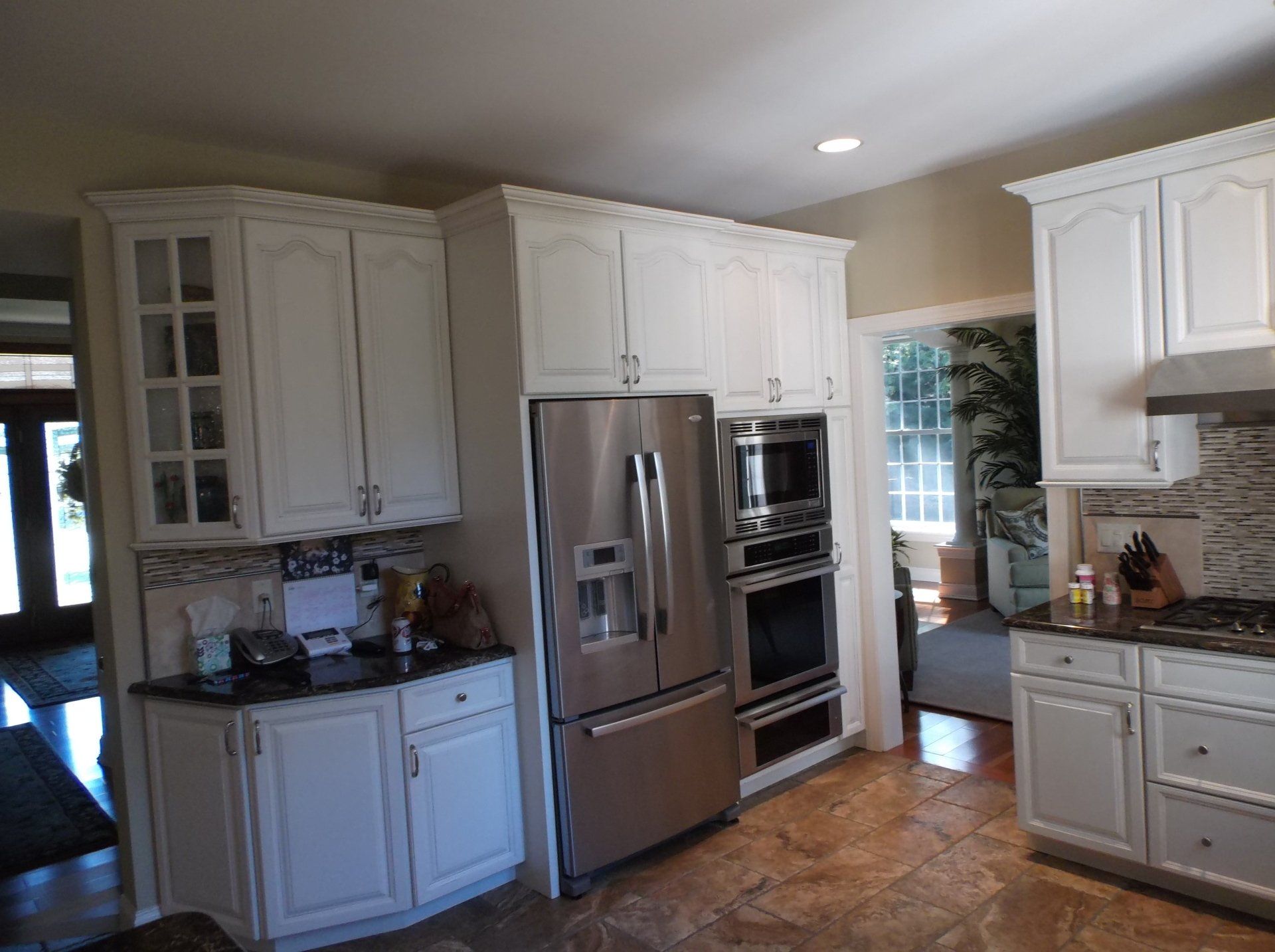 A kitchen with white cabinets and stainless steel appliances.