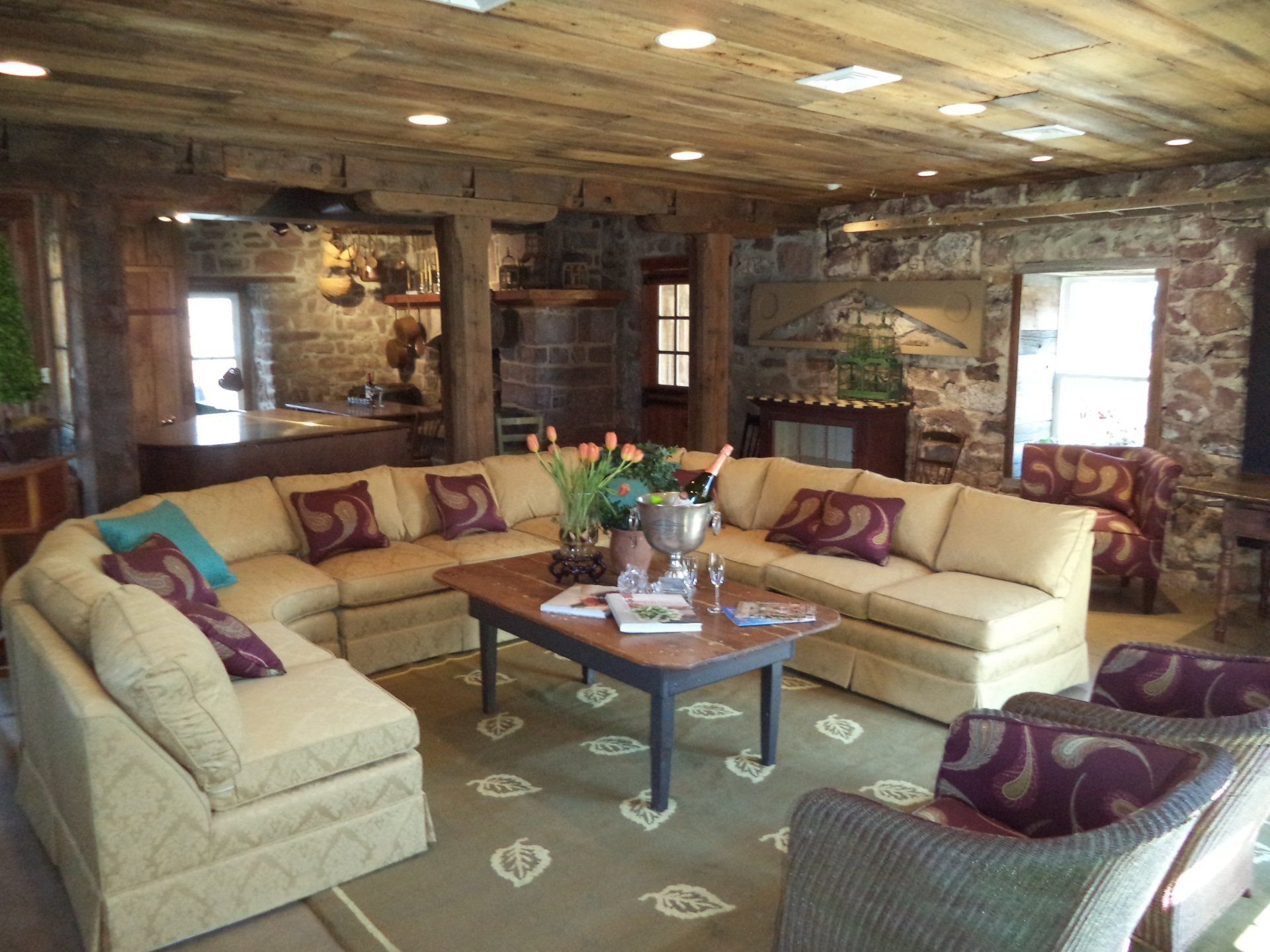 A living room with a large sectional couch and chairs