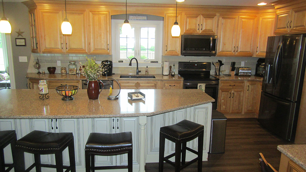 A kitchen with a large island and stools