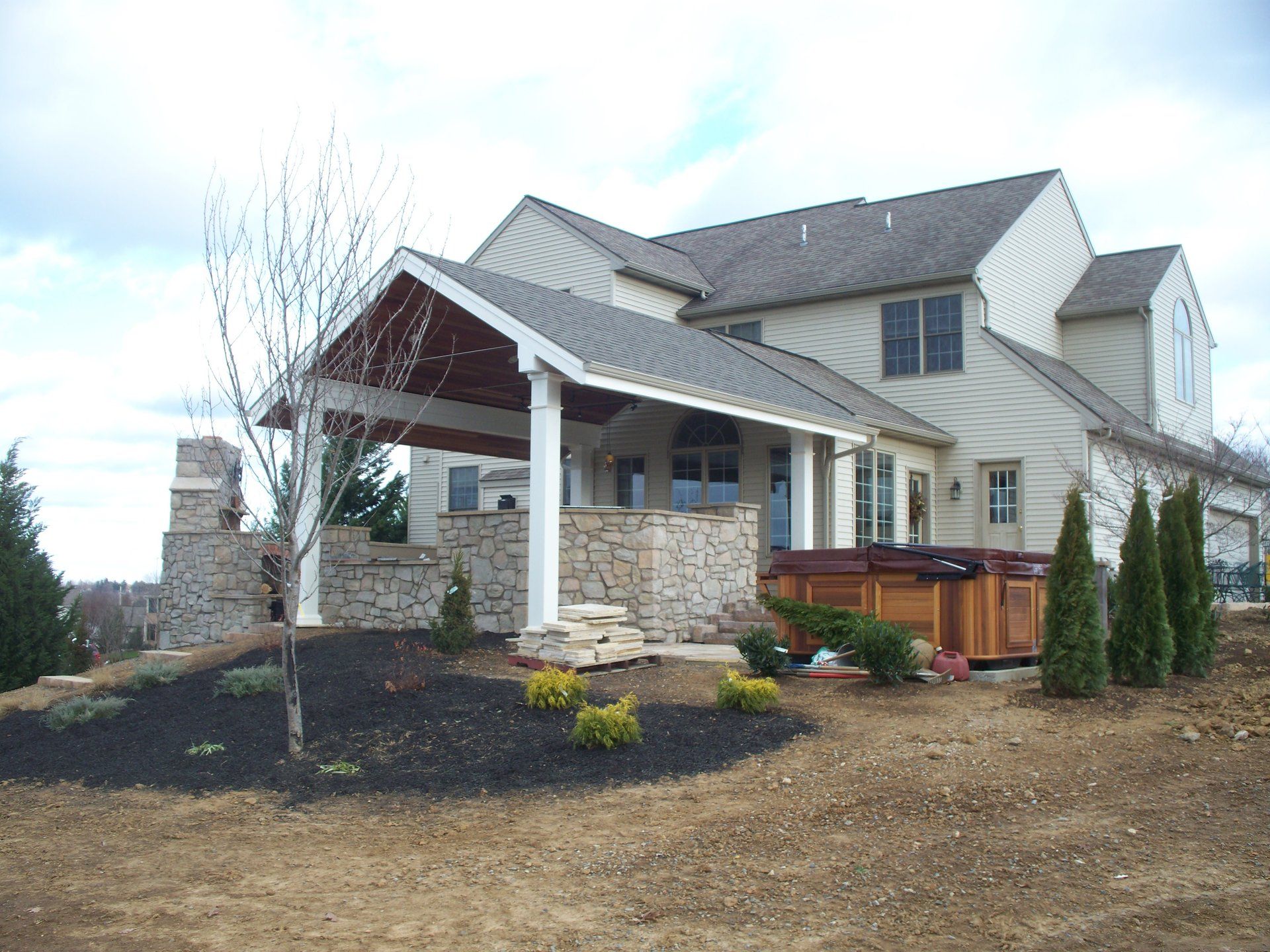 A large house with a hot tub in the backyard