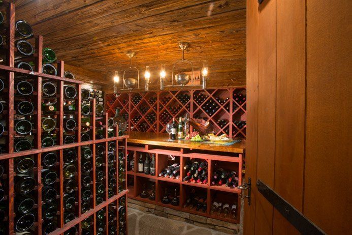 A wine cellar filled with lots of bottles of wine.