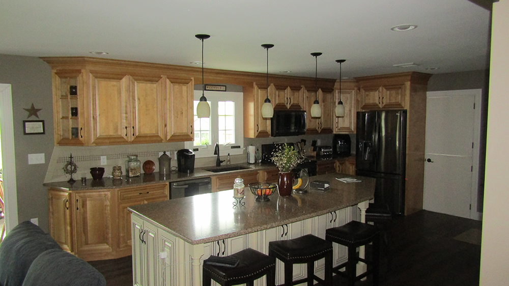 A kitchen with a large island and stools