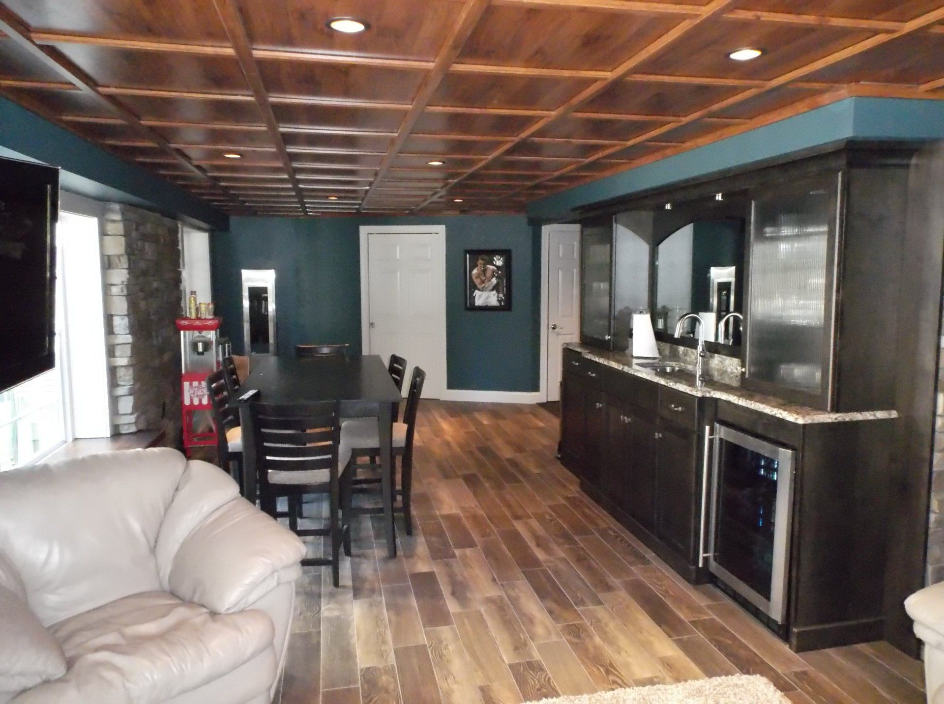 A living room with a table and chairs and a bar